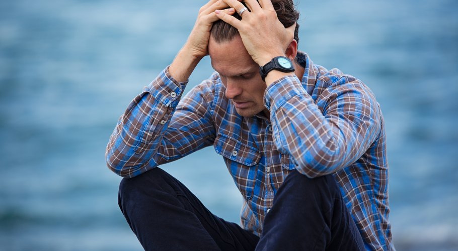 man-in-blue-and-brown-plaid-dress-shirt-touching-his-hair-897817