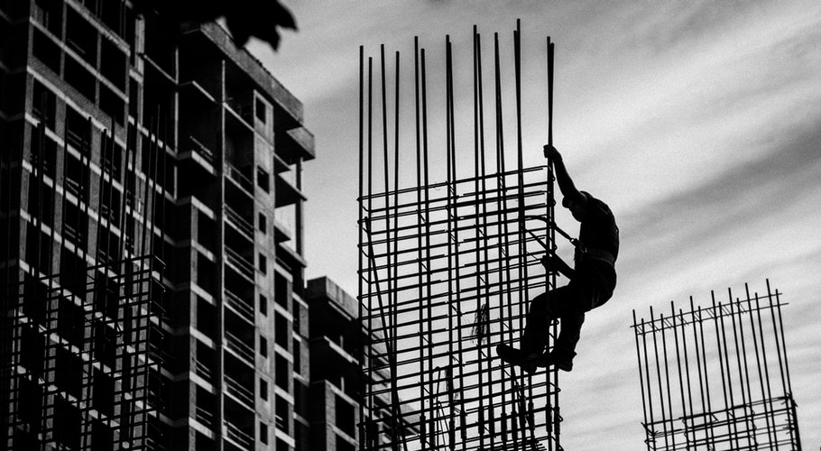 silhouette-of-man-holding-onto-metal-frame-3609139